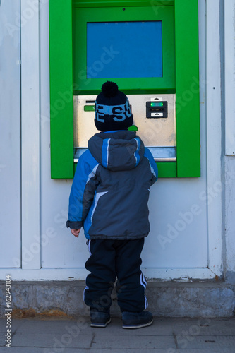  receiving money from an ATM machine photo