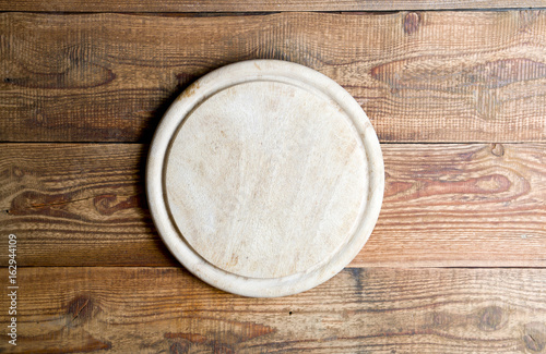 Kitchen board on the wooden background
