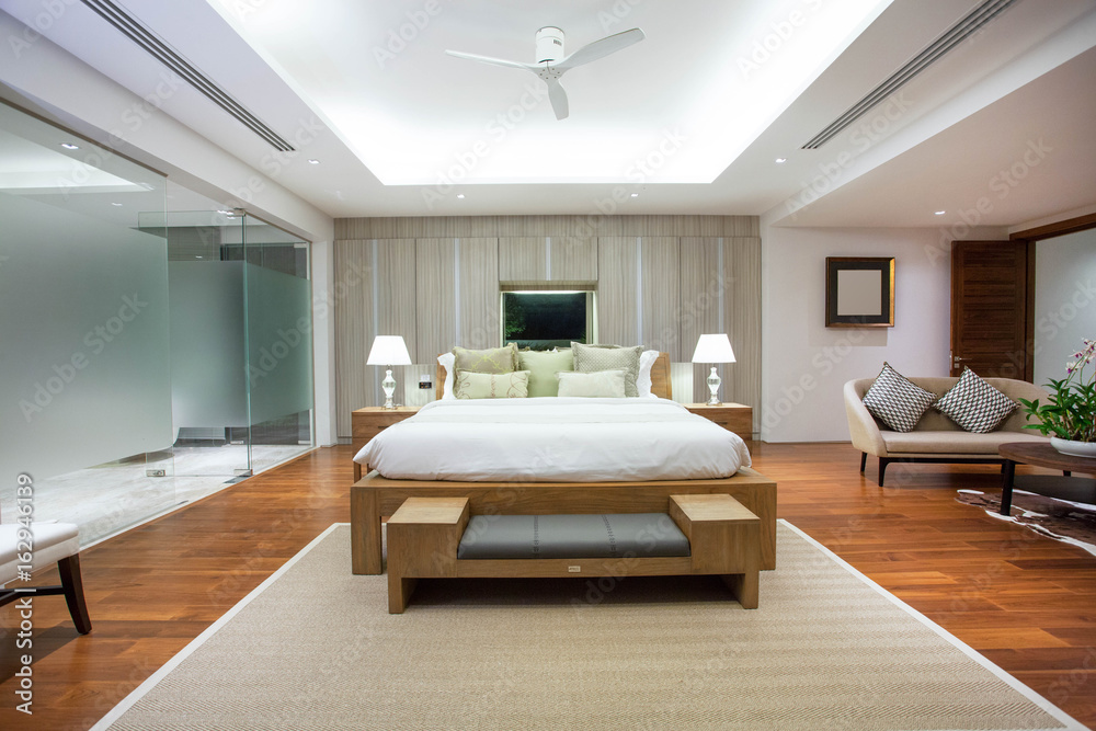 uxury Interior design in bedroom of pool villa with cozy king bed. Bedroom with high raised ceiling uxury Interior design in bedroom of pool villa with cozy king bed. Bedroom with high raised ceiling