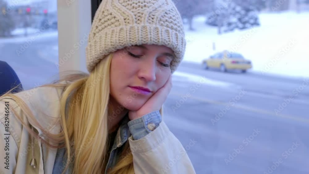 Tired Teen Girl Leans Against Train Window And Sleeps (Beautiful Winter Cityscape Passes By)