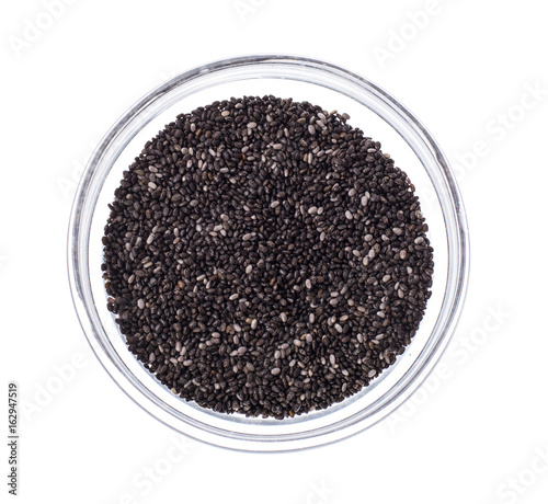 Chia seeds in glass on white background