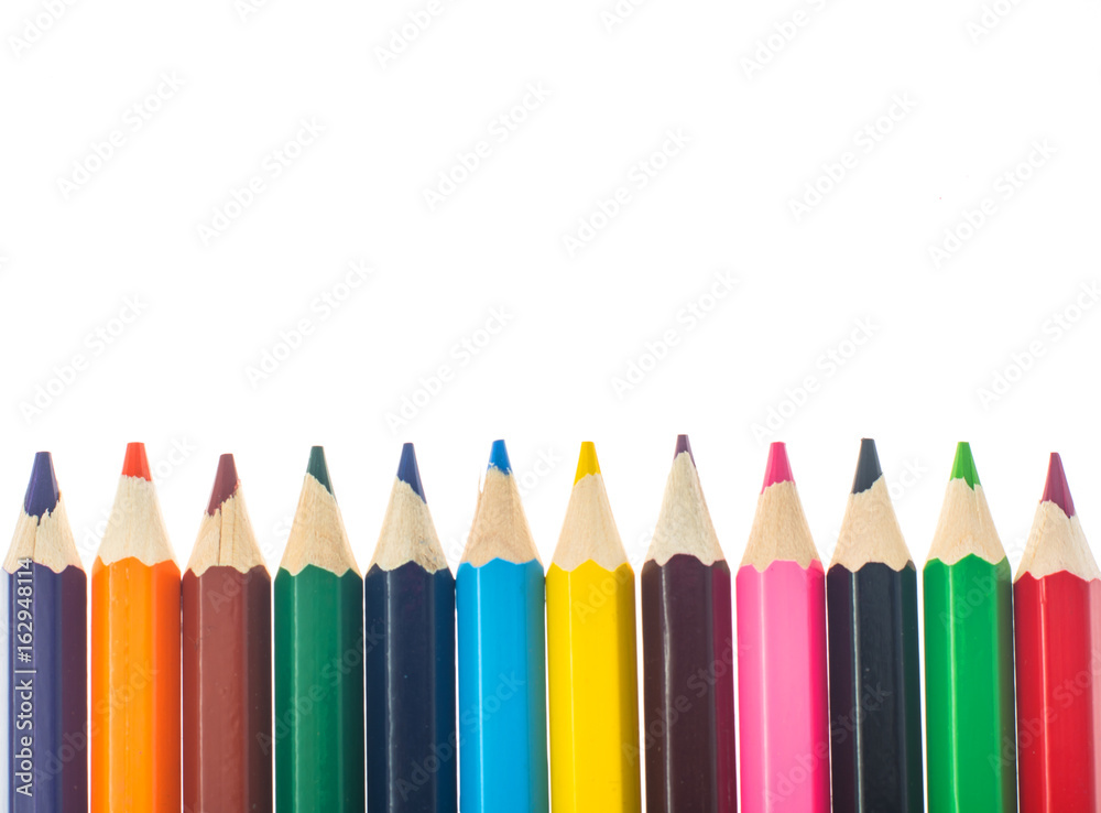 Fototapeta premium Line of colored pencils on white background