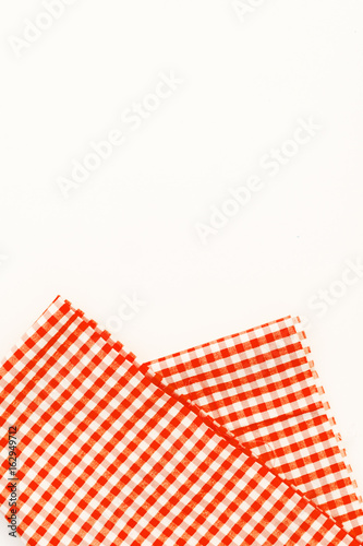 Orange cloth, a kitchen towel with a checkered pattern, on a white background isolated