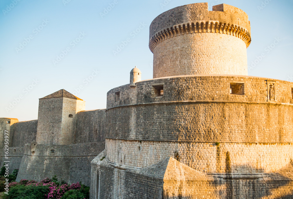 Minceta Tower at sanset lights and Dubrovnik medieval old town city walls in Croatia