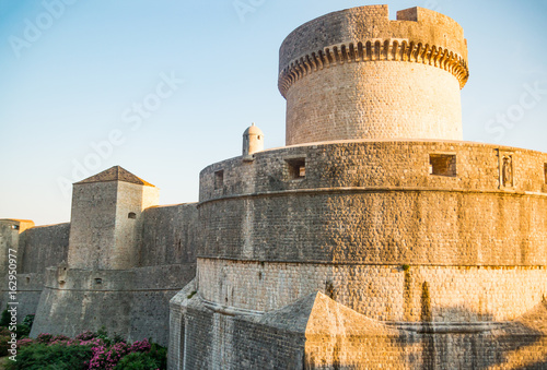 Minceta Tower at sanset lights and Dubrovnik medieval old town city walls in Croatia