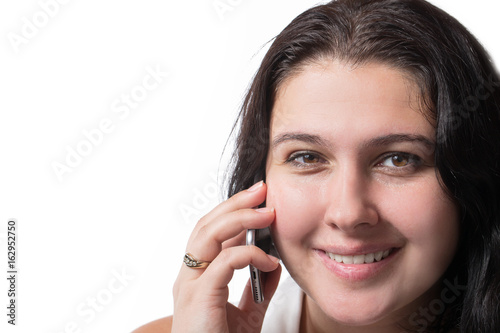 Smiley young woman speaking on mobile phone isolated on white