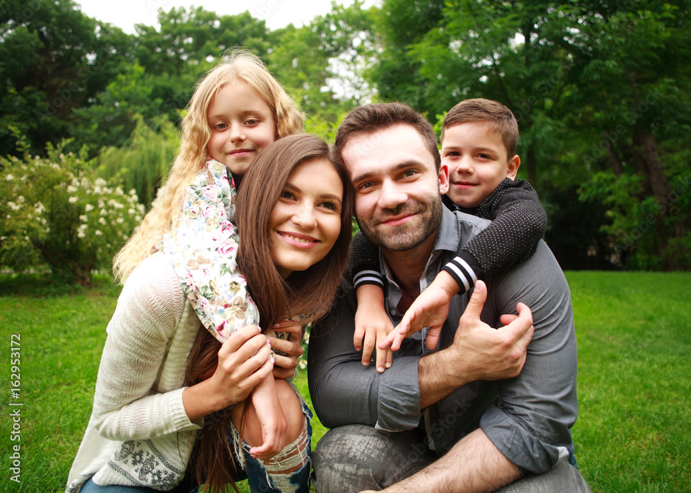 Portrait of a happy smiling family in city park Portrait of a happy smiling family in city park