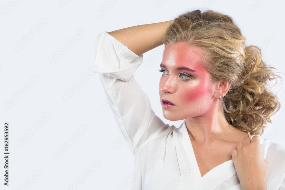 Beautiful blonde woman face with pink makeup. Glamour fashion model portrait with colorful pigment on the face, glossy skin, bright make-up. White backdrop Beautiful blonde woman face with pink makeup. Glamour fashion model portrait with colorful pigment on the face, glossy skin, bright make-up. White backdrop