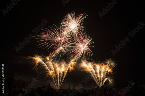 Layers of bright orange, red, green and white fireworks © Rachel Lerch