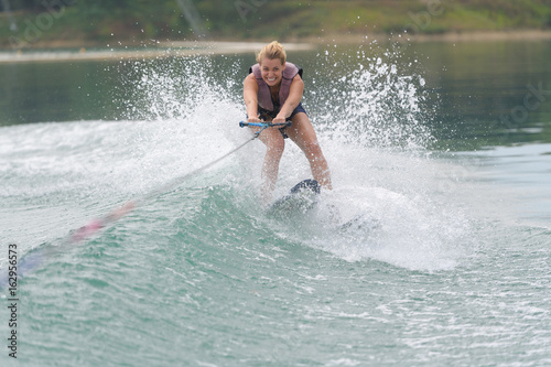 young woman study riding wakeboarding on a lake