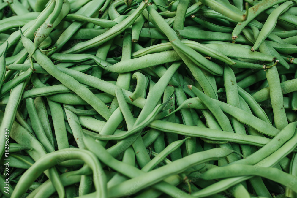 Green beans background. Natural local products on the farm market. Harvesting. Seasonal products. Food. Vegetables. Green beans background. Natural local products on the farm market. Harvesting. Seasonal products. Food. Vegetables.
