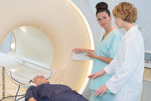 doctor and nurse talking about medical records mri photo