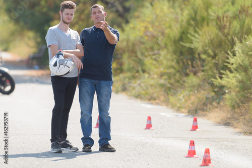 driving instructor explains man the exercise in motordrome photo