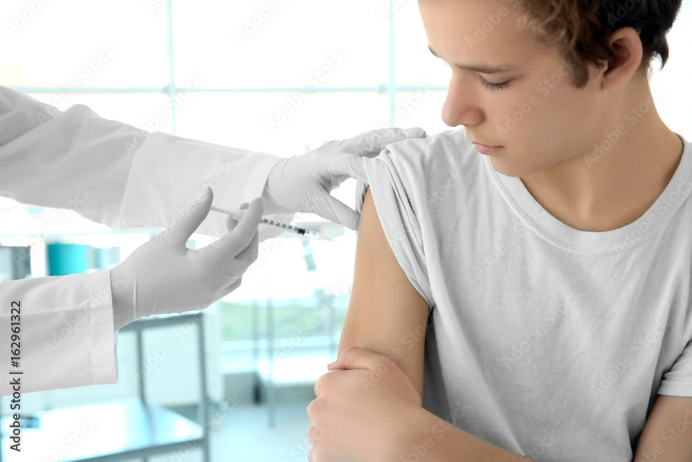 Doctor vaccinating patient in clinic Doctor vaccinating patient in clinic