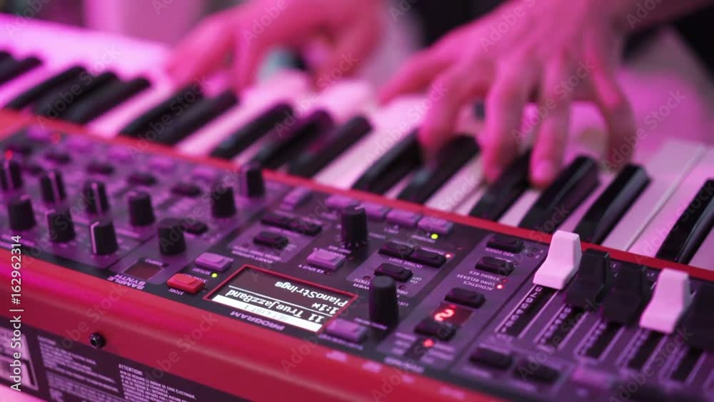 Man playing piano keyboard closeup