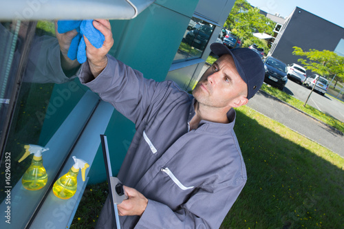 window cleaning employee with work tools photo