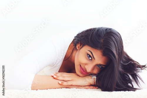 portrait of beautiful young indian woman on carpet