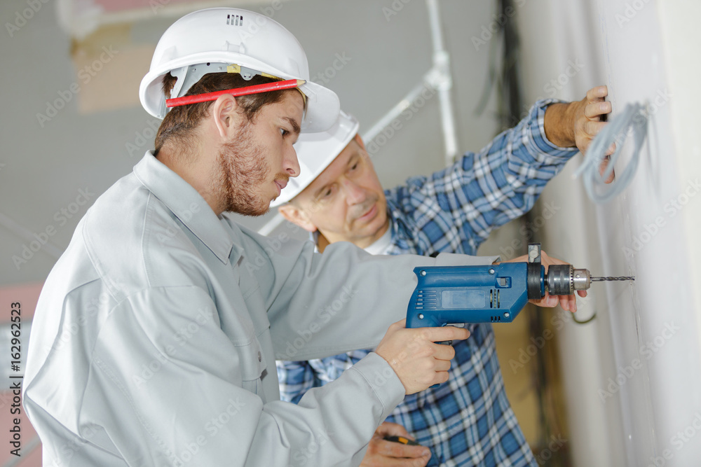craftsman watching over his apprentice craftsman watching over his apprentice