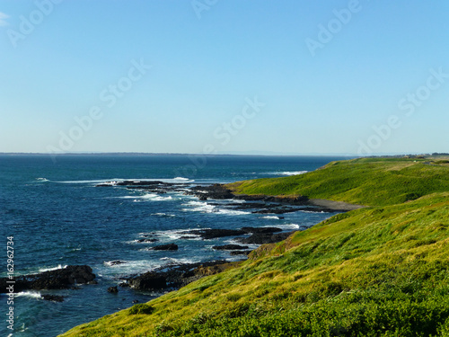 Green hills and an endless sea at tide