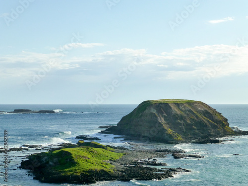 Small island or rock formation and an endless ocean