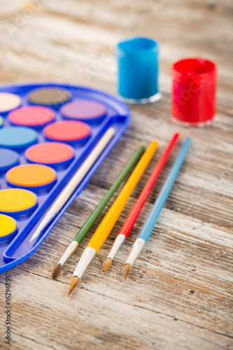 special painting tools on wooden background, education tools for schools