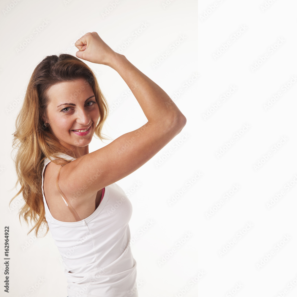 young beautiful woman showing her beautiful arms as a symbol of strength young beautiful woman showing her beautiful arms as a symbol of strength