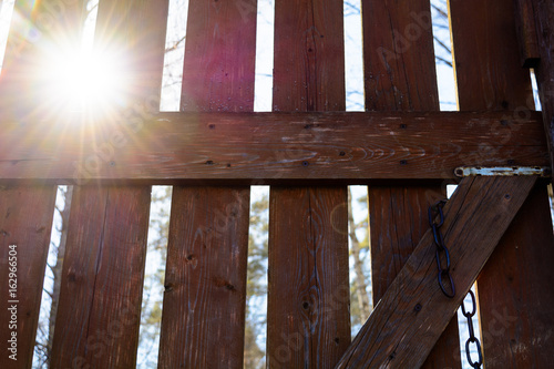 Sunlight through wooden gate