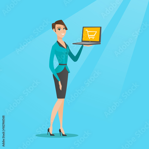 Woman holding laptop with trolley on a screen.