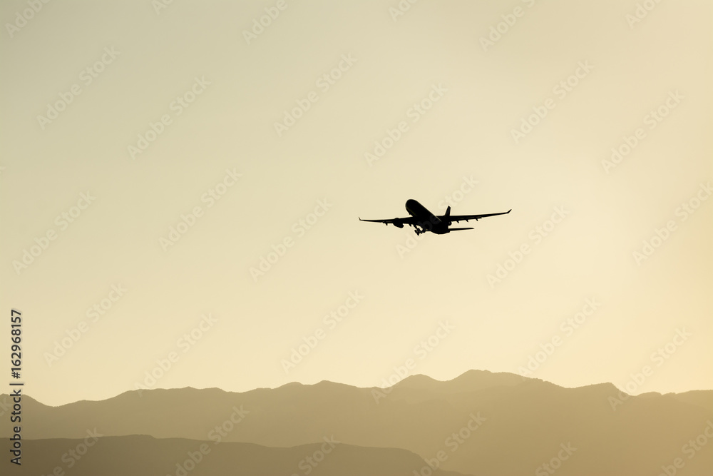 Airplane taking off over the mountains. Airplane taking off over the mountains.