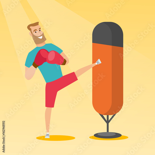 Young caucasian man exercising with punching bag.