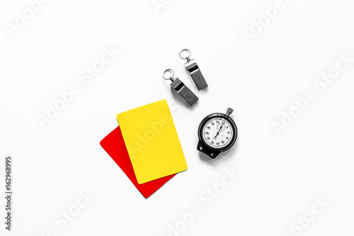 Yellow and red cards, stopwatch, whistle on white background top view copyspace photo