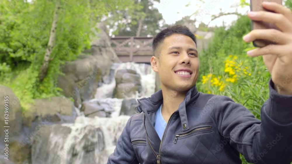 Attractive Man Takes A Selfie In Front Of A Waterfall, Then Reviews His Photos Attractive Man Takes A Selfie In Front Of A Waterfall, Then Reviews His Photos