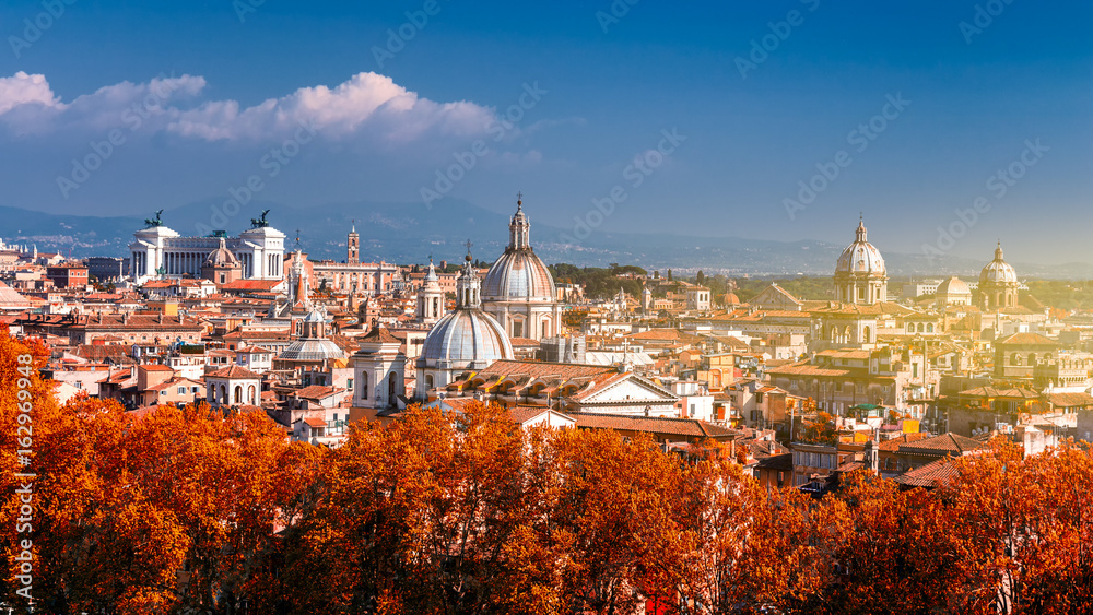 Panoramic autumn view over the historic center of Rome, Italy from Castel Sant Angelo. Red foliage.