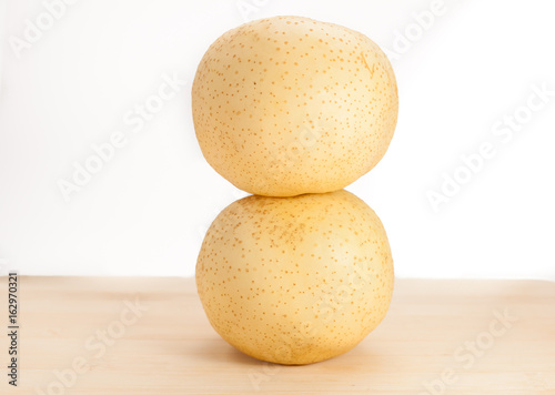 two pear stack together on wooden background