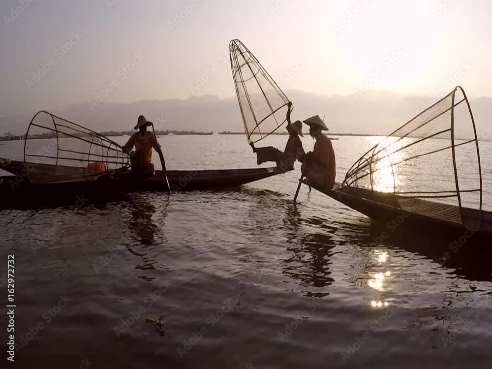 Leg rowing fishermen on Inle Lake, Myanmar, show off their cultural traditions in their hand carved canoes. Leg rowing fishermen on Inle Lake, Myanmar, show off their cultural traditions in their hand carved canoes.