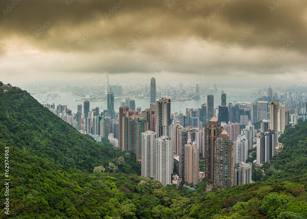 Panorama photo of hi resolution dramatic Hong Kong city skyline view lookout from top of Victoria Peak in a hazy cloudy and foggy day