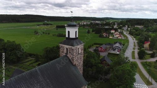 Kemio church, Aerial view around old medieval stone church revealing kemio town, on a summer day, in Kemionsaari, varsinais-suomi, Finland photo