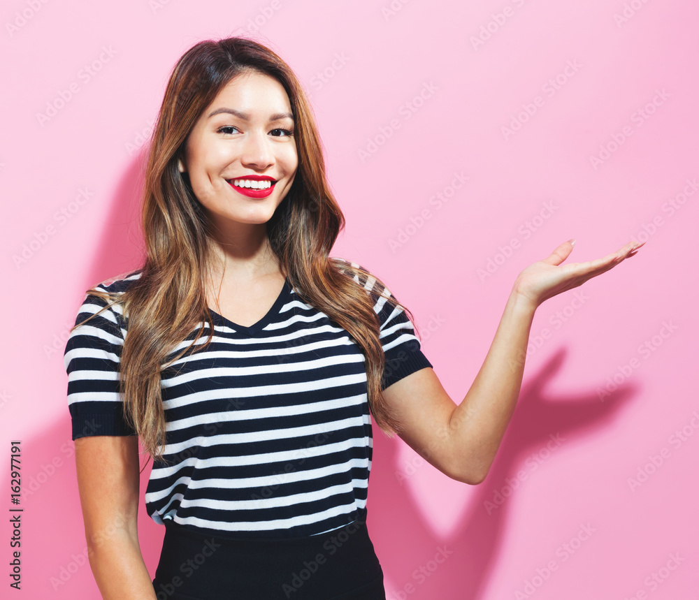 Young woman with a displaying hand gesture