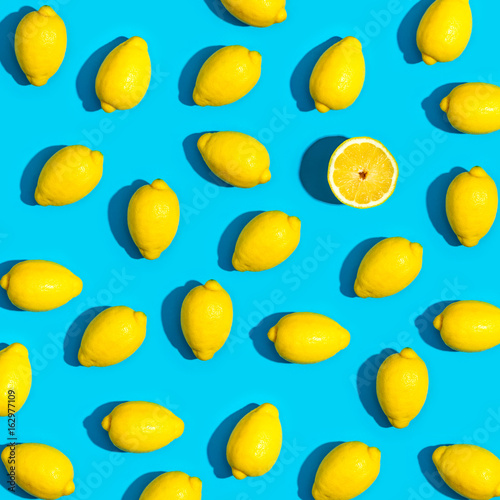Fresh lemon pattern on a vivid blue background flat lay