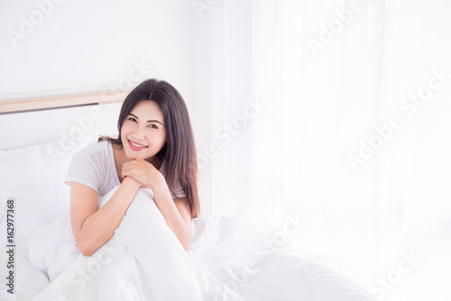 Beautiful asian girl resting on bed in morning
