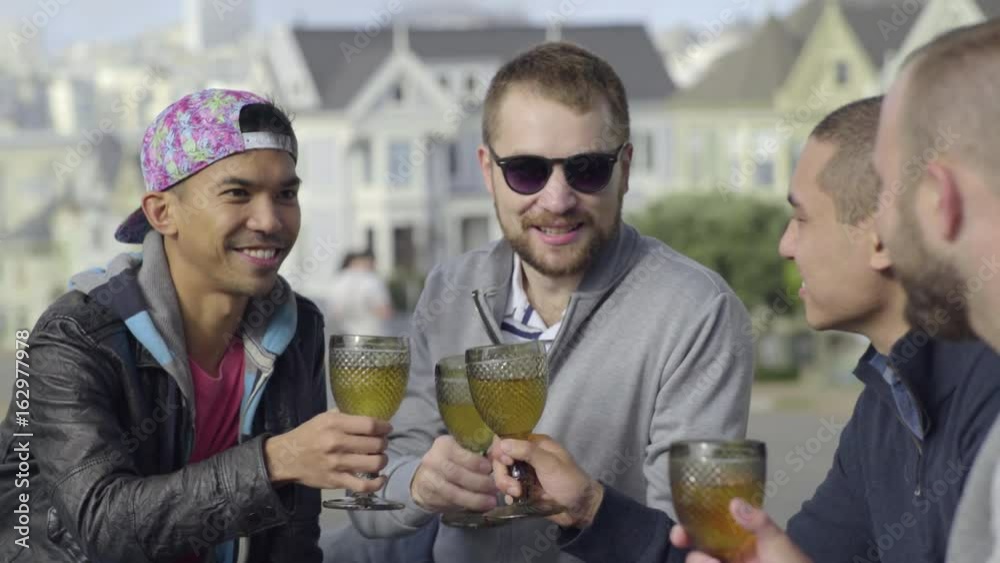 Two Gay Couples Toast With Wine In Alamo Square, San Francisco 