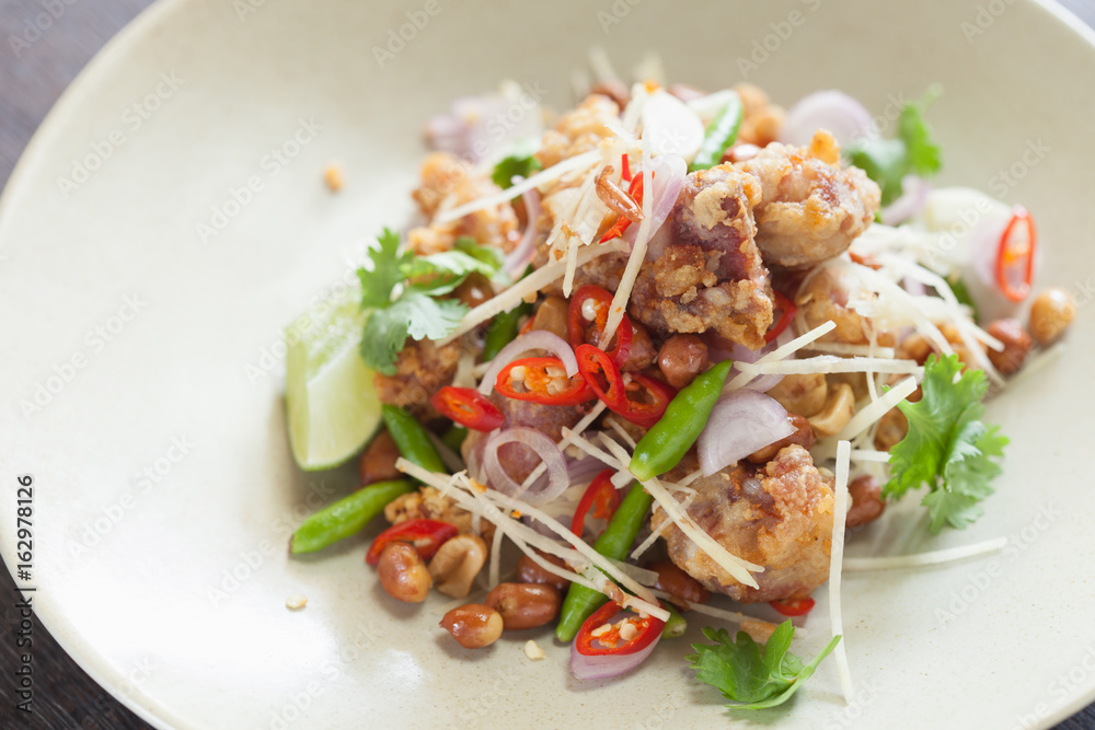 Spicy fried pork salad in thaifood with vegetable.