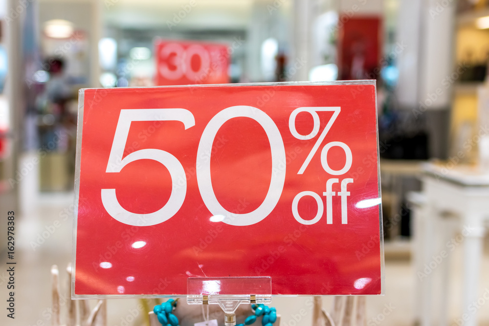 Sale sign 50 percent discount on a blurred background in a shopping mall of Bali, Indonesia, Asia.