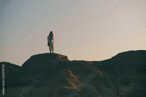 Women with white shirt standing on a rock in Thailand stone canyon or Sam Pan Bok. Ubonratchathani Province ,Thailand