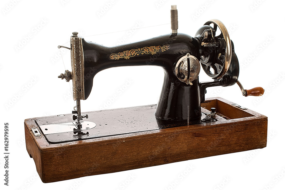 An old, hand sewing machine on white background