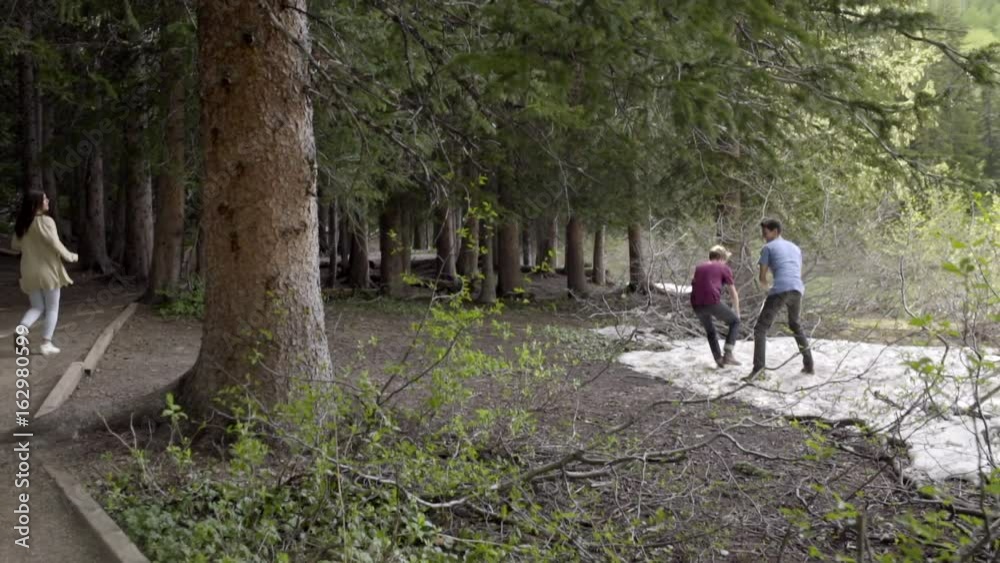 Group Of Teens Run Into Forest, Boys Find Patch Of Snow, Have A Snowball Fight In Summer (Slow Motion) Group Of Teens Run Into Forest, Boys Find Patch Of Snow, Have A Snowball Fight In Summer (Slow Motion)
