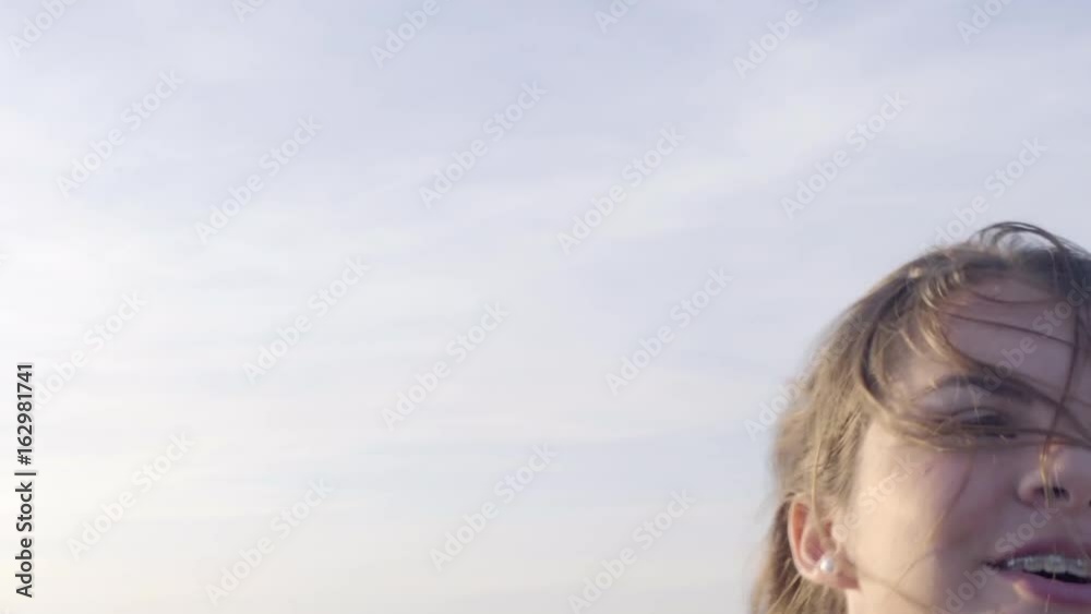 Excited Teen Girl Stands Up In Backseat Of Moving Jeep, She Puts Her Arm In The Air Excited Teen Girl Stands Up In Backseat Of Moving Jeep, She Puts Her Arm In The Air
