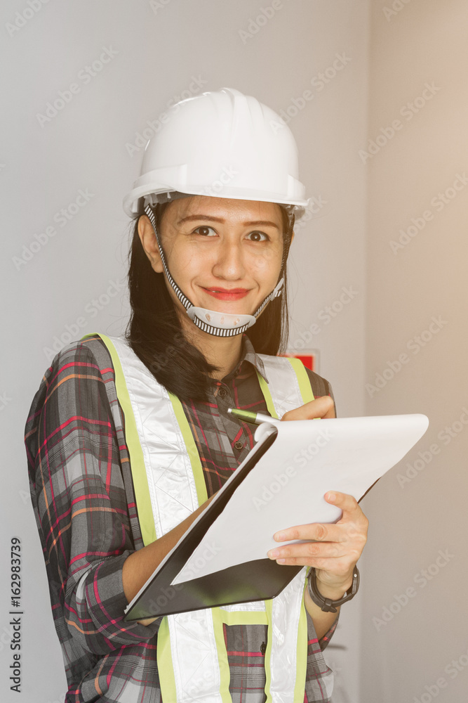 women engineer working on checking and maintenance electrical equipment ;women engineer checking status switchgear with checklist
women engineer working on checking and maintenance electrical equipment ;women engineer checking status switchgear with checklist