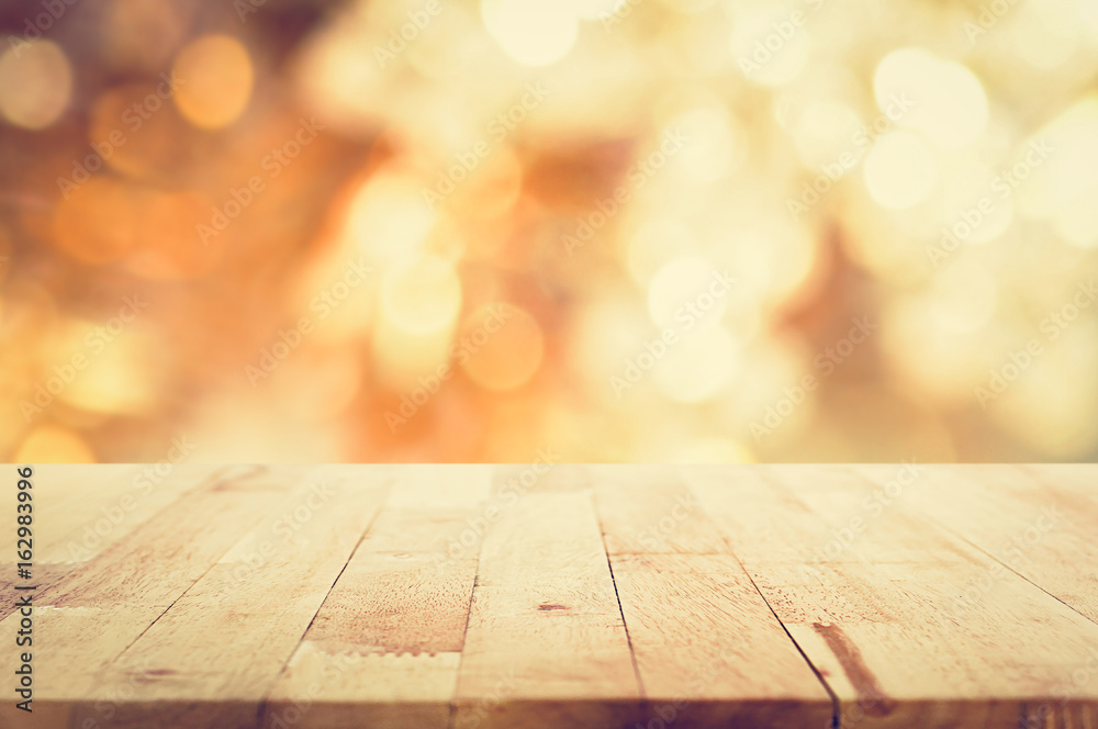 Wood table top on golden bokeh background Wood table top on golden bokeh background