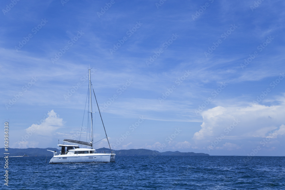 Sea, blue sky, white clouds, green mountains and beautiful boats floating in the sea. Sea, blue sky, white clouds, green mountains and beautiful boats floating in the sea.
